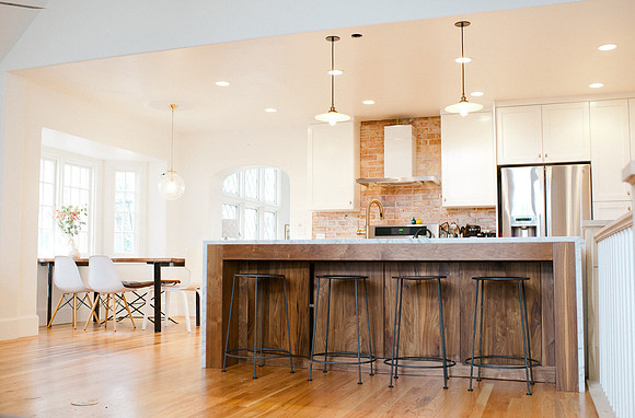 Modern White kitchen with Walnut island and Brass hardware
